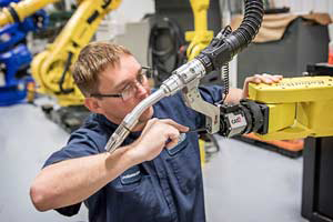 RobotWorx_Employee_Repairing_Welding_Robot.png#asset:68